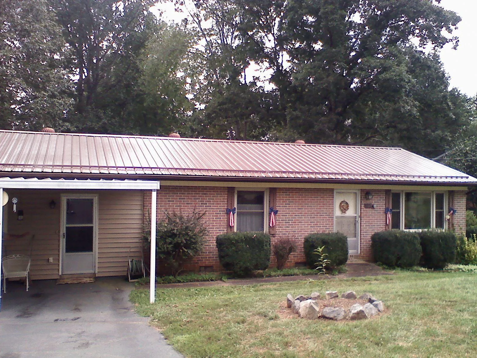 Bronze metal roof and carport on a brick ranch home — Roof Repair work by our crew in Mechanicsville